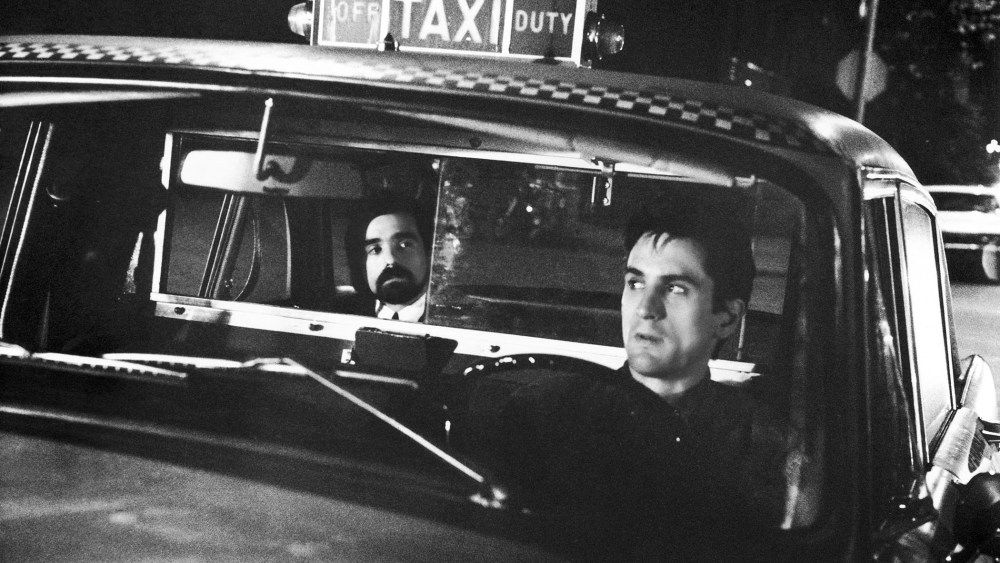 In this photo taken on the set of Taxi Driver, Martin Scorcese acts as a passenger as Robert De Niro plays Travis Bickle, a disgruntled cab driver in New York, Feb. 8, 1976. (Photo by Entertainment Pictures/ZUMA)