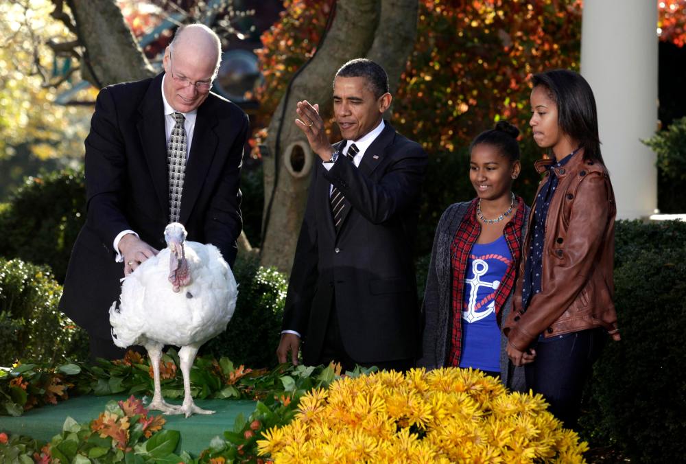 U.S. President Barack Obama pardons the 2012 Thanksgiving Turkey, Cobbler, next to next to his daughters Sasha and Malia (R) and National Turkey Federation Chairman Steve Willardsen in the Rose Garden of the White House in Washington, November 21, 2012...