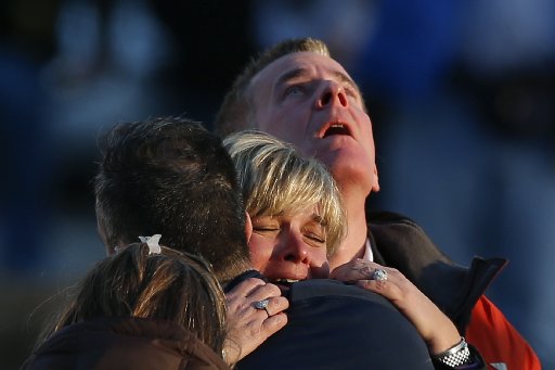 The families of victims grieve near Sandy Hook Elementary School, where a gunman opened fire on school children and staff in Newtown, Connecticut on December 14, 2012. (Photo by Reuters/Adrees Latif)