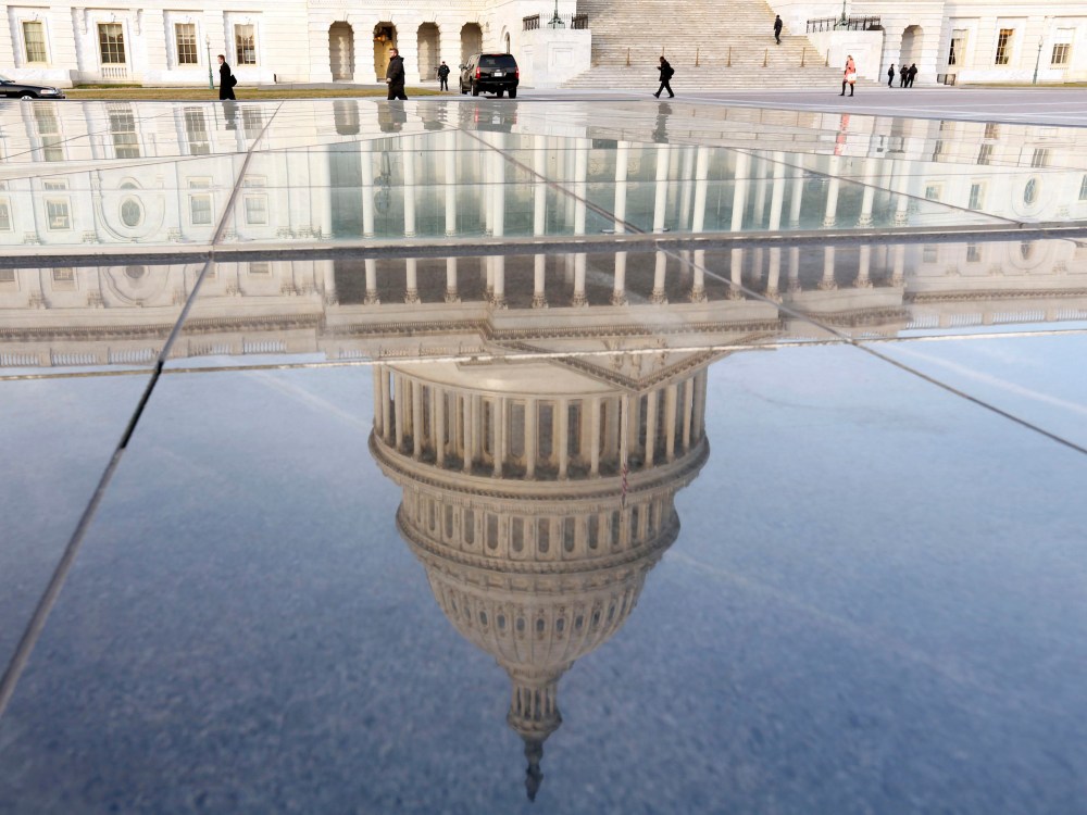 Image: The dome of the U.S. Capitol is reflected on the first day of the 113th Congress in Washington