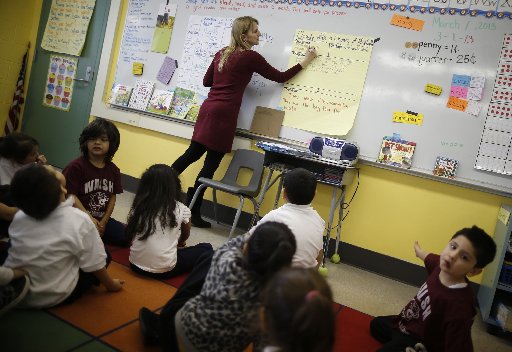 Teacher Audrey Benes speaks to her kindergarten class at Walsh Elementary School in Chicago, Illinois, March 1, 2013. According to officials in U.S. President Barack Obama's administration, possible consequences of impending across-the-board U.S....