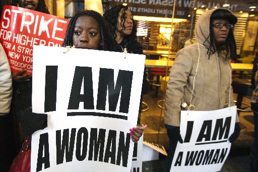 Demonstrators protesting low wages and the lack of union representation in the fast food industry chant and hold signs outside of a McDonald's restaurant near Times Square in New York, April 4, 2013. (REUTERS/Lucas Jackson)