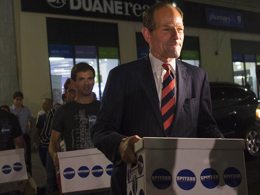 Former New York Governor Eliot Spitzer (front) delivers signatures to the board of elections office in New York July 11, 2013. Spitzer, who is attempting a political comeback five years after resigning from office in a prostitution scandal, is leading...