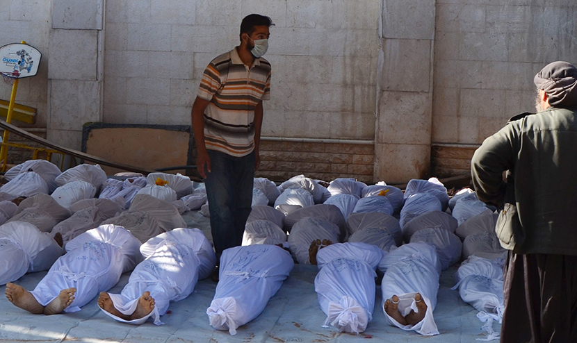 Image: Syrian activists inspect the bodies of people they say were killed by nerve gas in the Ghouta region, in the Duma neighbourhood of Damascus
