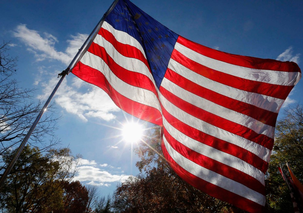 An American flag is seen during a protest in Lafayette Park, across the street from the White House in Washington, November 19, 2013.