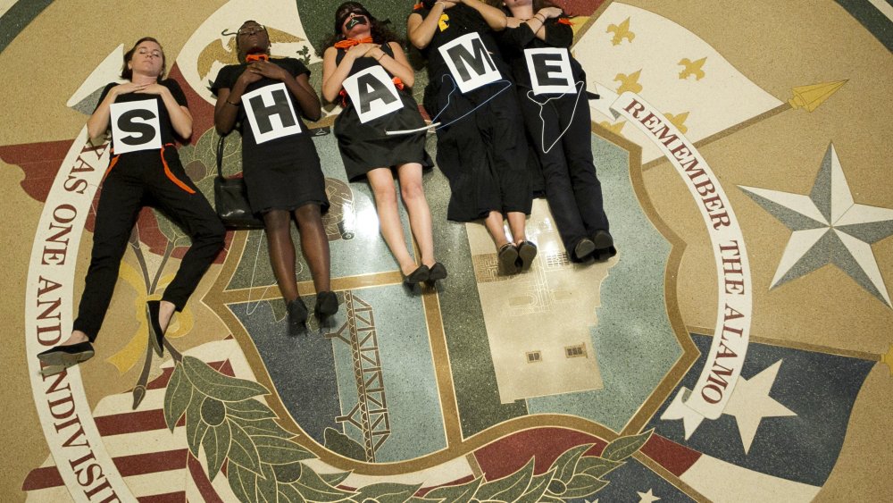 July 18, 2013 - Austin, Texas, U.S. - Abortion rights supporters demonstrate outside the Capitol auditorium where Gov. R. Perry signed the abortion restriction bill that will outlaw abortions after 20 weeks and force abortion clinics and doctors to...