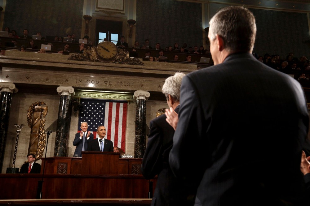 White House Chief of Staff Denis McDonough (R) and Secretary of State John Kerry (2nd R) applaud President Barack Obama as he delivers his State of the Union speech on Capitol Hill in Washington, Jan 28, 2014.