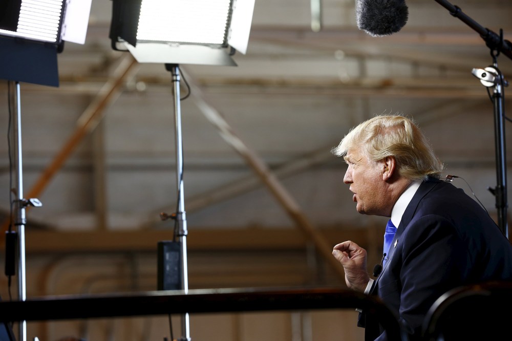 Republican presidential candidate Donald Trump gives an interview to Bill O'Reilly of Fox News before speaking at a campaign rally in Mesa, Ariz., Dec. 16, 2015. (Photo by Nancy Weichec/Reuters)