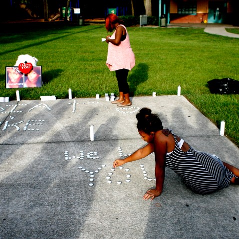 Lashell Bell, 18, right, of Tampa places candles spelling out ''We Love You'' during a vigil on July 22, 2015 in Florida, in memory of India Clarke. (Photo by Octavio Jones/Tampa Bay Times/Zuma)