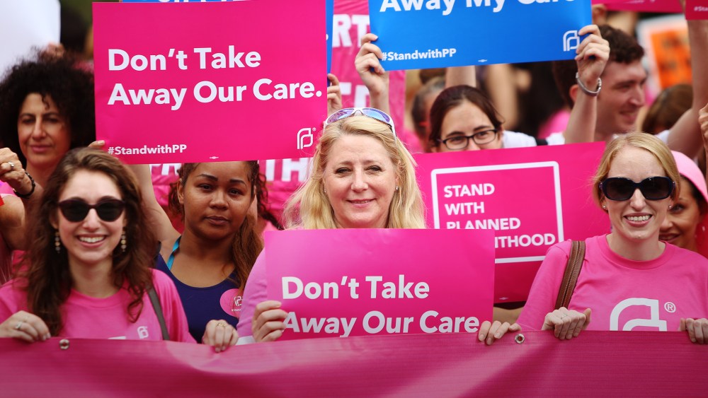 Pro-choice protesters hold pink Planned Parenthood banner and signs in Foley Square, New York, Sept. 29, 2015. (Photo by Andy Katz/Pacific Press/ZUMA)