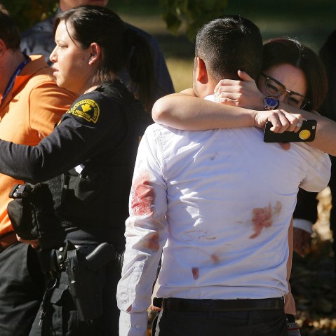 A couple embraces following the shooting rampage in San Bernardino, Calif., that killed at least 14 people and wounded others at Inland Regional Center. (Photo by David Bauman/The Orange County Register/ZUMA)