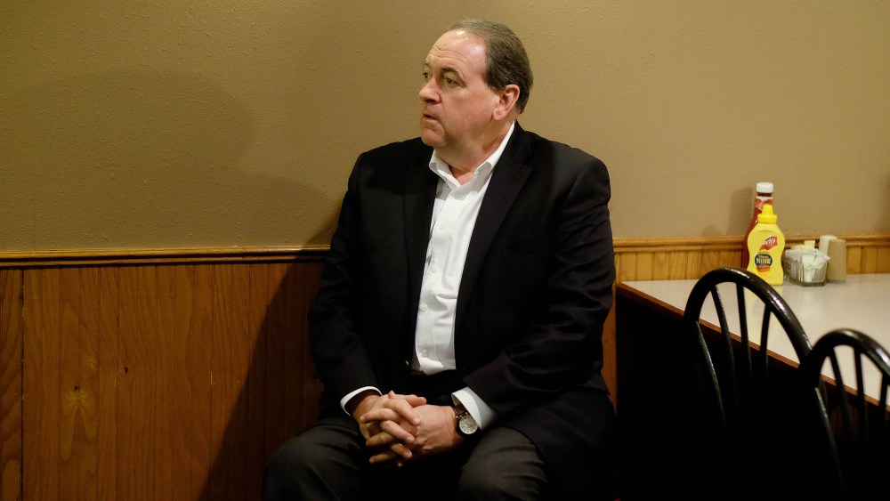Republican presidential candidate and former Arkansas Gov. waits for an introduction at the Sioux County Livestock Co. restaurant in Sioux Center, Iowa, Dec. 17, 2015. (Photo by Jerry Mennenga/ZUMA)