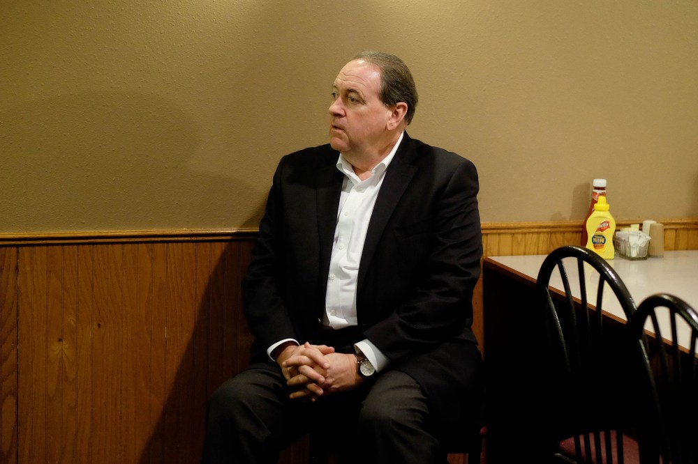 Republican presidential candidate and former Arkansas Gov. waits for an introduction at the Sioux County Livestock Co. restaurant in Sioux Center, Iowa, Dec. 17, 2015. (Photo by Jerry Mennenga/ZUMA)