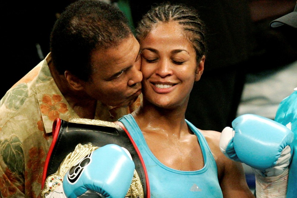 WBC and WIBA super middleweight champion Laila Ali is kissed by her father, boxing great Muhammad Ali, at the MCI Center in Washington on June 11, 2005. (Photo by Jason Reed/Reuters)