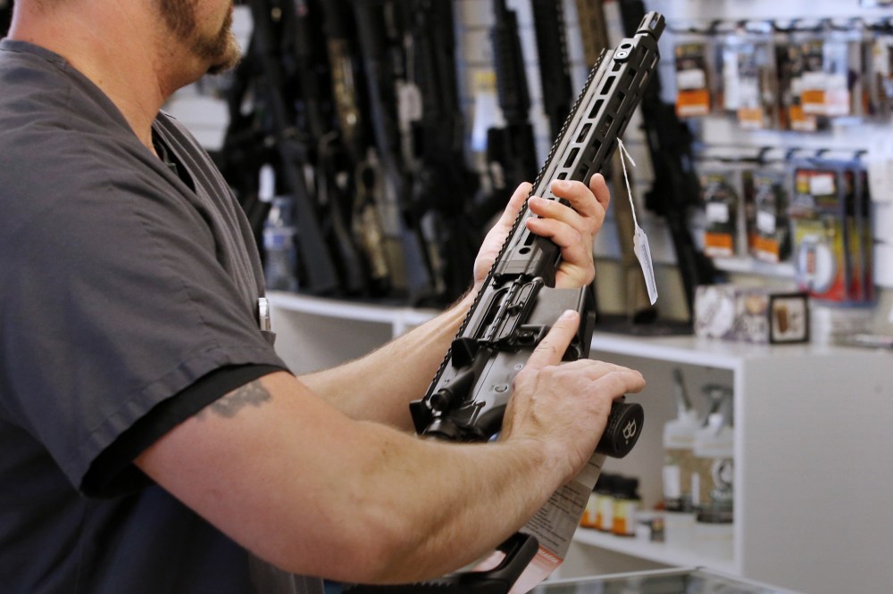 A prospective buyer examines an AR-15 at the "Ready Gunner" gun store In Provo, Utah, June 21, 2016. (Photo by George Frey/Reuters)