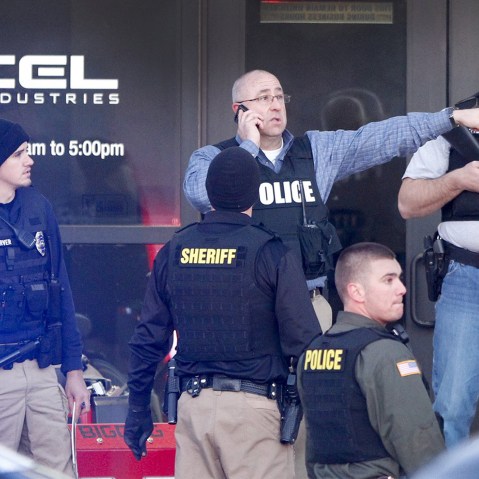 Police guard the front door of Excel Industries where a gunman reportedly killed up to three people and injured as many as 14 others on Feb. 25, 2017 in Hesston, Kan. (Photo by Fernando Salazar/TNS/ZUMA)
