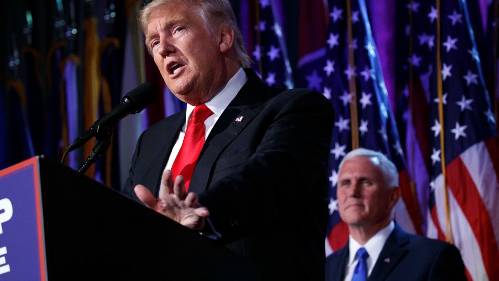 Vice president-elect Mike Pence, watches as President-elect Donald Trump speaks during an election night rally, Nov. 9, 2016, in N.Y. (Photo by Evan Vucci/AP)