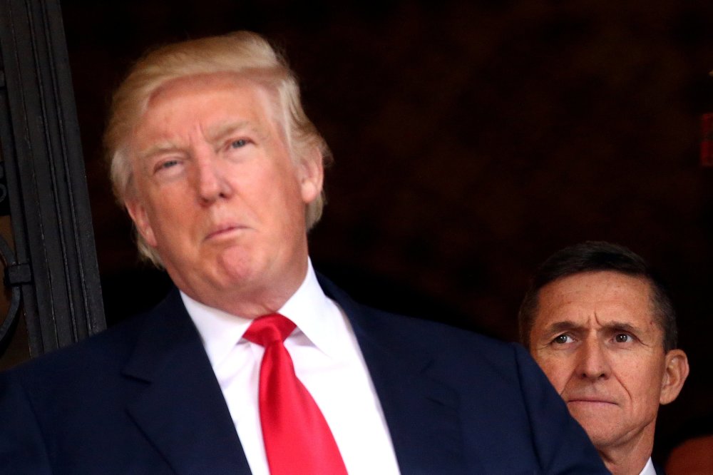 Image: FILE PHOTO: U.S. Army Lieutenant General Michael Flynn looking at U.S. President-elect Donald Trump in Palm Beach, Florida