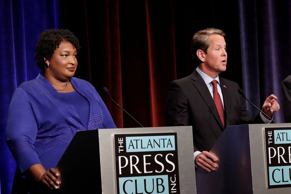 Republican gubernatorial candidate for Georgia Brian Kemp speaks as Democratic candidate Stacey Abrams looks on during a debate in Atlanta, Georgia, U.S, October 23, 2018. Picture taken on October 23, 2018.