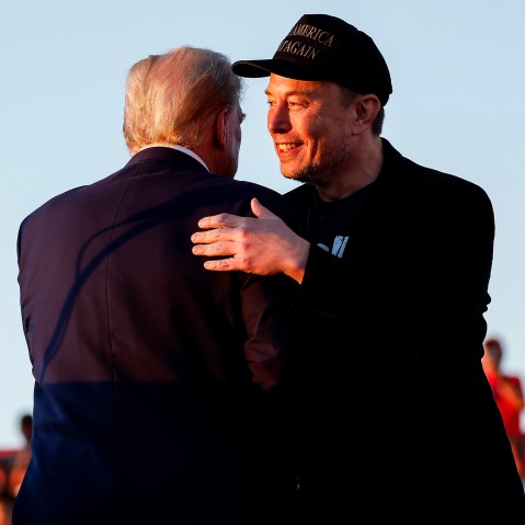 Elon Musk embraces Republican presidential nominee, and former President Donald Trump in Butler, Pa. on Oct. 5, 2024.