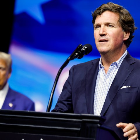 Tucker Carlson speaks alongside Republican presidential nominee, and former U.S. President Donald Trump during a Turning Point Action campaign rally in Duluth, Georgia on October 23, 2024.