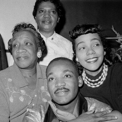 Dr. Martin Luther King, Jr., is embraced by his wife Coretta Scott King during a news conference at Harlem Hospital in New York, Sept 30, 1958. At left is his mother, Alberta Williams King.