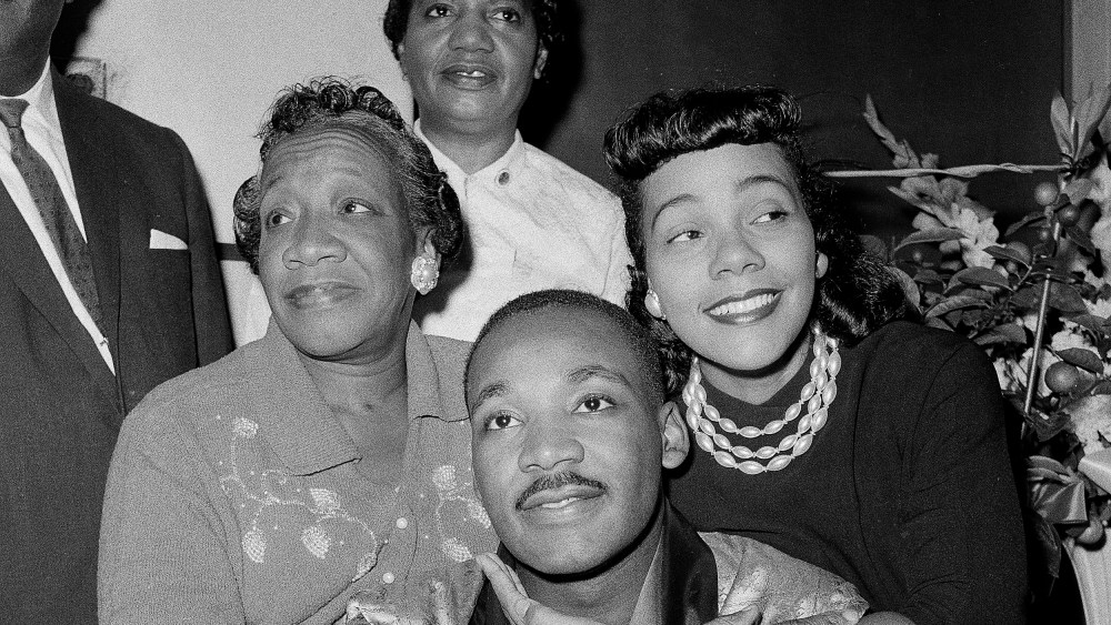 Dr. Martin Luther King, Jr., is embraced by his wife Coretta Scott King during a news conference at Harlem Hospital in New York, Sept 30, 1958. At left is his mother, Alberta Williams King.