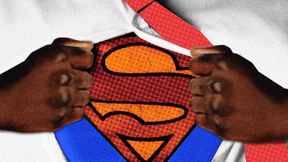 Photo illustration: A Black man's hands reveal the Superman logo under his shirt.