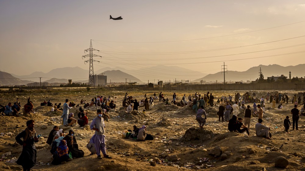 A military transport plane takes off while Afghans who cannot evacuate are stranded in Kabul on Aug. 23, 2021.