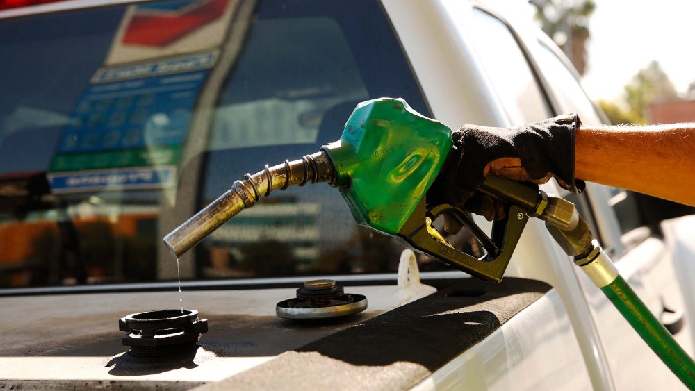 A driver fills up their tank at a Chevron Gas Station in downtown Los Angeles in November 2021, when gas prices hit an average price of $4.676, the highest recorded average price for regular gasoline, according to AAA.