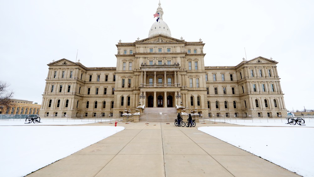 Police patrol the grounds outside the Michigan state capitol building on January 20, 2021 in Lansing.