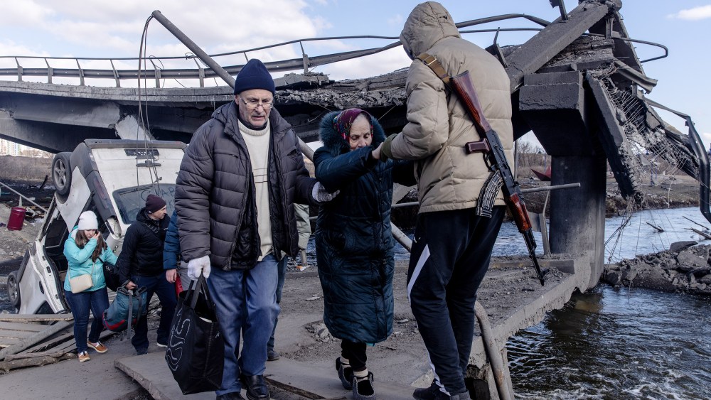 Residents of Irpin and Bucha flee via a destroyed bridge on Thursday, March 10 in Irpin, Ukraine.