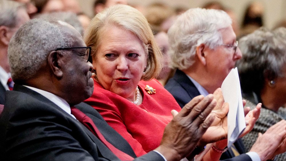 Associate Supreme Court Justice Clarence Thomas sits with his wife and conservative activist Virginia "Ginni" Thomas October 21, 2021 in Washington, DC.