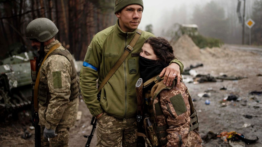 Ukrainian army soldier Igor, 23, embraces his wife Dasha, 22, after a military sweep to search for possible remnants of Russian troops after their withdrawal from villages in the outskirts of Kyiv on Friday, April 1.