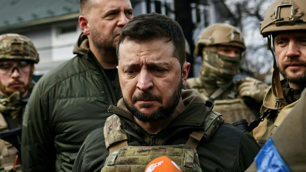 Ukainian President Volodymyr Zelensky speaks to the press in the town of Bucha on Monday, April 4.