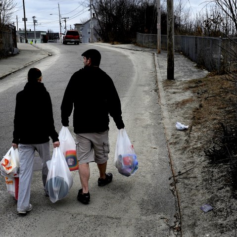 WOONSOCKET, RI - MARCH 01: (L) Amanda Aubin and Cody Allison carry $70.00 worth of groceries to their apartment about one-half mile away. They had money left over on their food stamp card but this amount of food was all that they could carry on foot. Some of the items purchased were for their 4 year-old daughter who was having a birthday party the next day. Many families and individuals in Woonsocket, Rhode Island are needy and take part in the SNAP (food stamps) program.