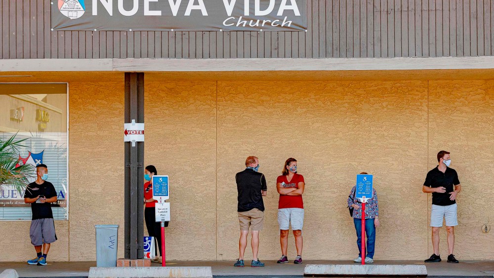 People wait in line to vote at a polling place at the Scottsdale Plaza Shopping Center, in Scottsdale, Ariz. on November 3, 2020.