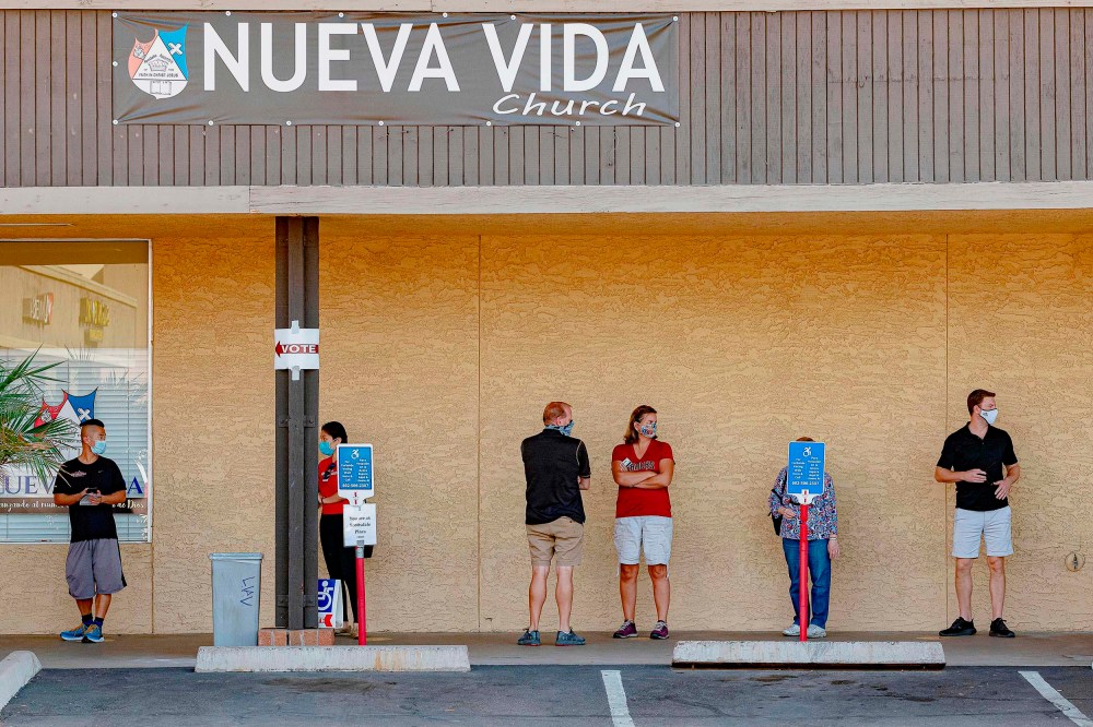 People wait in line to vote at a polling place at the Scottsdale Plaza Shopping Center, in Scottsdale, Ariz. on November 3, 2020.