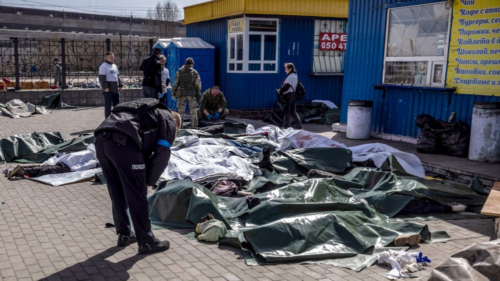 Image: A Ukrainian policeman looks at victims of a rocket attack that killed at least 35 people at a train station in Kramatorsk on April 8, 2022.