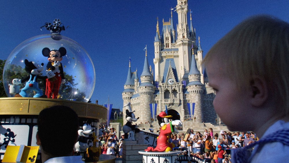 Image: Mickey Mouse rides through Main Street near Cinderella's castle at Disney World in 2001.