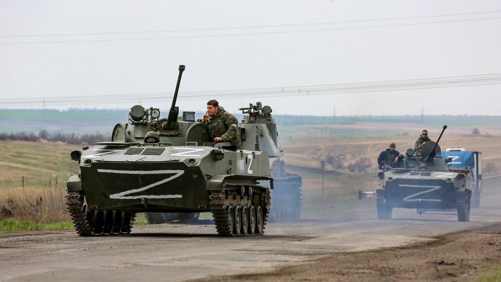 Russian military vehicles move on a highway in an area controlled by Russian-backed separatist forces near Mariupol, Ukraine, on April 18, 2022.
