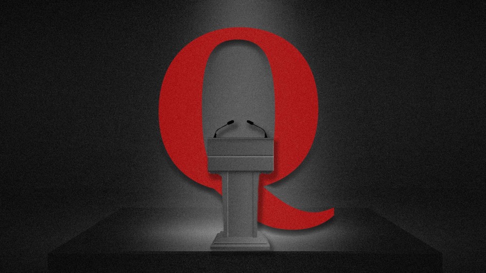 Photo Illustration: The QAnon logo behind a debate podium
