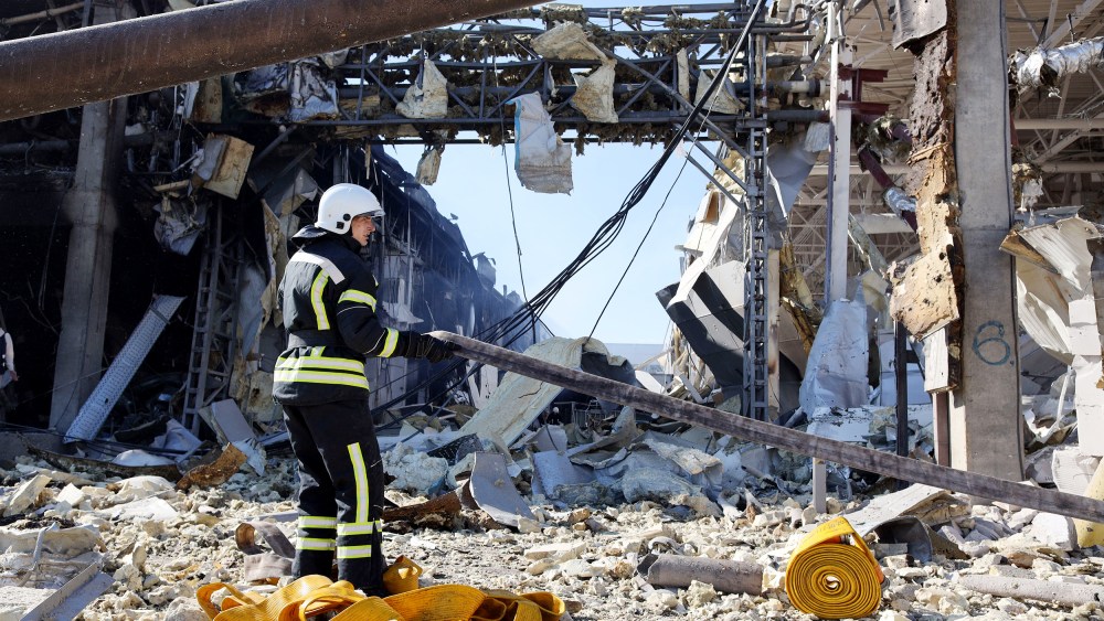 A rescue worker gestures in front of the shopping and entertainment center in the Ukrainian Black Sea city of Odessa on Tuesday, May 10 destroyed after Russian missiles strike late on Monday, May 9.