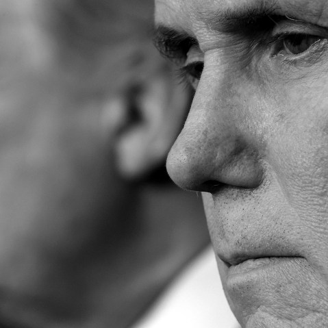 Image: A close-up shot of Mike Pence with Donald Trump in the background.