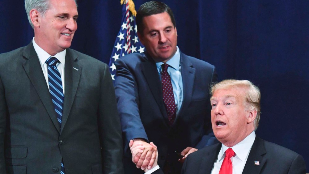 Former President Donald Trump shakes hands with Devin Nunes as Rep. Kevin McCarthy looks on during a meeting in Scottsdale, Ariz. on October 19, 2018.