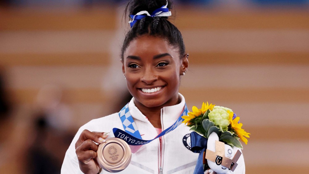 Simone Biles poses with the bronze medal during the Women's Balance Beam Final medal ceremony at the Tokyo 2020 Olympic Games on Aug. 3, 2021.