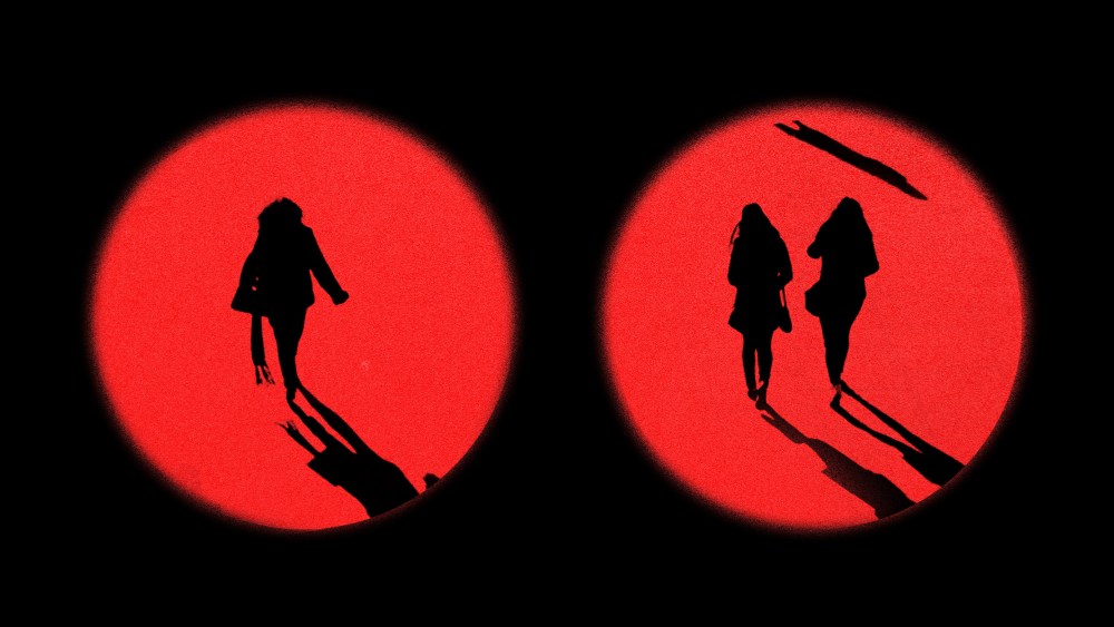 Photo illustration: Two red circles showing women walking in the distance.