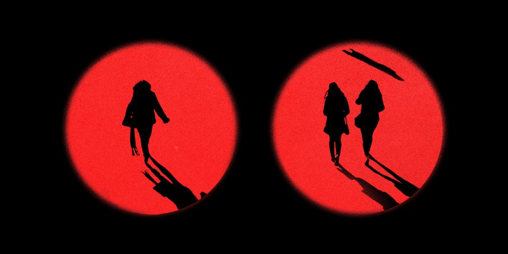 Photo illustration: Two red circles showing women walking in the distance.