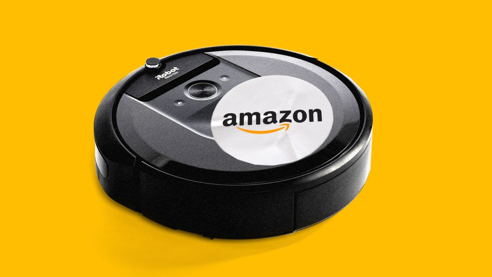 Photo illustration: A Roomba with a sticker with an Amazon logo on it.