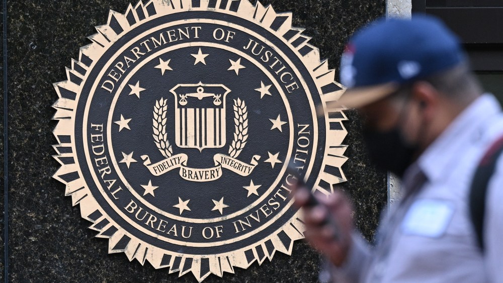 A pedestrian walks past the J. Edgar Hoover FBI building, in Washington, D.C. on August 15.